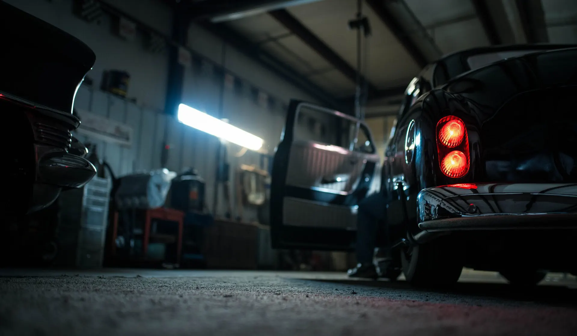 Car parked inside a repair workshop bay
