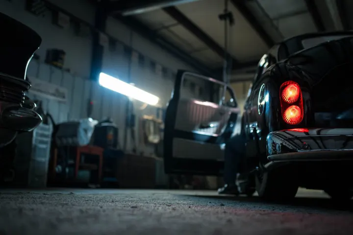 Car parked inside a repair workshop bay