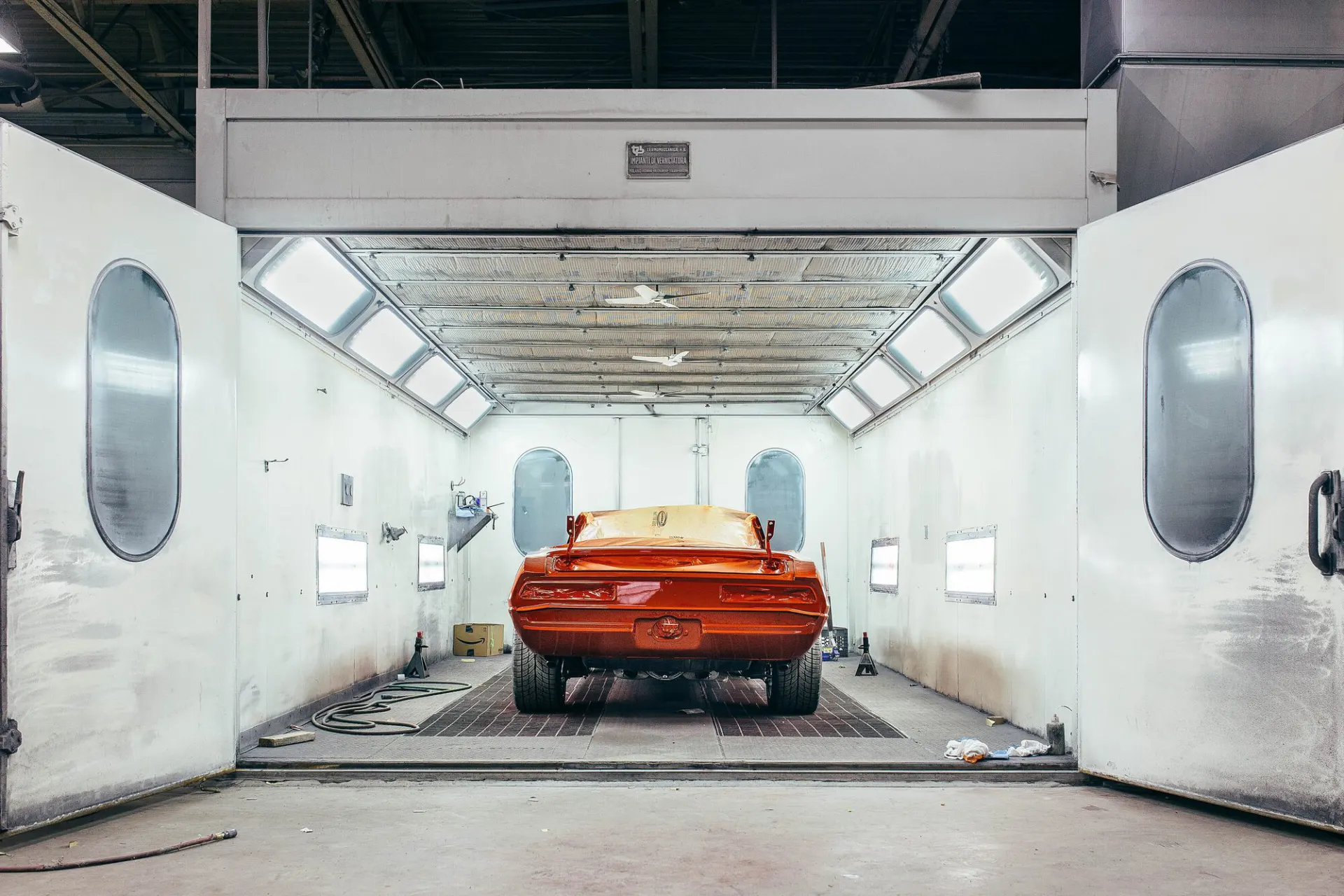 Car with fresh paintwork inside a spray painting booth
