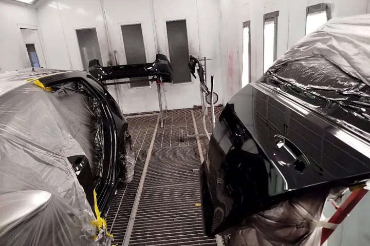 Black panels and bumper in the spray booth at NG Crash Repairs, Finglas