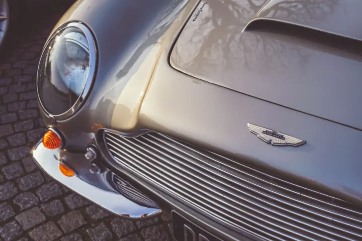 Close-up of a silver car body panel and grille